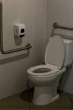 Empty toilet for background. Toilet with handrails for the disabled. Focus on the lid of the toilet. stock photography Empty toilet for background. Toilet with handrails for the disabled. Focus on the lid of the toilet. stock photography