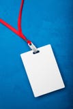 Empty white blank badge on blue background with red neck stock photo Empty white blank badge on blue background with red neck stock photo