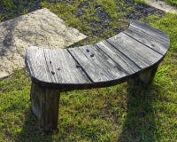 Empty wooden bench on the grass stock image Empty wooden bench on the grass stock image