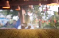Empty wooden table in front of abstract blurred green of garden and house background. For montage product display or design key royalty free stock photos Empty wooden table in front of abstract blurred green of garden and house background. For montage product display or design key royalty free stock photos