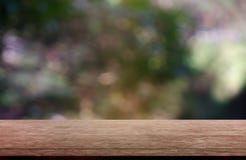 Empty wooden table in front of abstract blurred green of garden and nature light background. For montage product display or design stock photography Empty wooden table in front of abstract blurred green of garden and nature light background. For montage product display or design stock photography