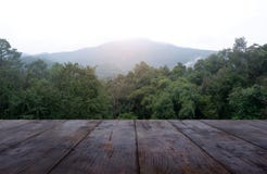 Empty wooden table in front of green nature and mountain background. For montage product display or design key visual layout - royalty free stock photos Empty wooden table in front of green nature and mountain background. For montage product display or design key visual layout - royalty free stock photos