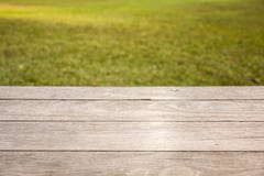 Empty wooden table on garden background stock photo Empty wooden table on garden background stock photo