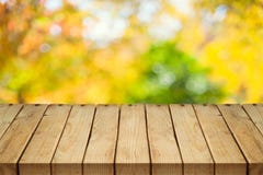 Empty wooden table over autumn nature bokeh royalty free stock photo Empty wooden table over autumn nature bokeh royalty free stock photo