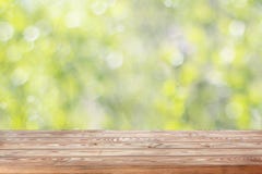 Empty wooden table top on blurred spring background with bokeh. Stock Images Empty wooden table top on blurred spring background with bokeh. Stock Images