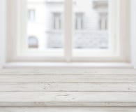 Empty wooden table top for product display over blurred window stock image Empty wooden table top for product display over blurred window stock image