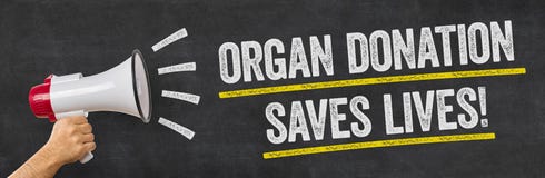 En man som rymmer en megafon - organdonation sparar liv royaltyfria bilder En man som rymmer en megafon - organdonation sparar liv royaltyfria bilder