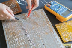 Engineer hands measure the voltage current on the electronic board f stock photo Engineer hands measure the voltage current on the electronic board f stock photo