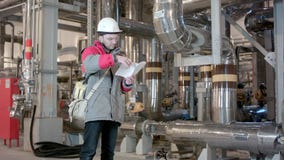Engineer Inside Power Plant With Checklist stock video Engineer Inside Power Plant With Checklist stock video