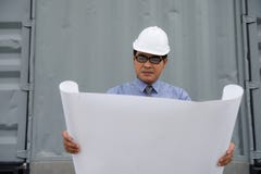Engineer manager look at consturction paper plan royalty free stock images Engineer manager look at consturction paper plan royalty free stock images