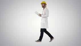 Engineer manager walking with hard hat is holding paper and checking on gradient background. royalty free stock photo Engineer manager walking with hard hat is holding paper and checking on gradient background. royalty free stock photo