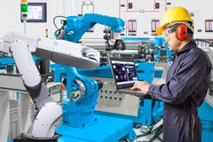 Engineer using laptop computer for maintenance automatic robotic stock photo Engineer using laptop computer for maintenance automatic robotic stock photo