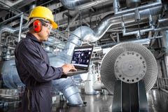 Engineer using laptop computer in thermal power plant factory