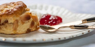 Englische Scones mit gegeronnenem Creme- und Erdbeerstau und neuem s lizenzfreies stockbild Englische Scones mit gegeronnenem Creme- und Erdbeerstau und neuem s lizenzfreies stockbild