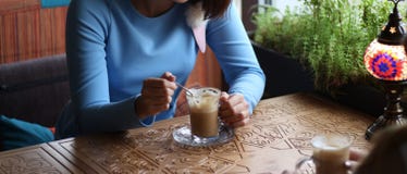 meeting with the client.enjoying in cafe together. Young women meeting in a cafe. meeting in a cafe for coffee. blue dress, sittin stock photos meeting with the client.enjoying in cafe together. Young women meeting in a cafe. meeting in a cafe for coffee. blue dress, sittin stock photos