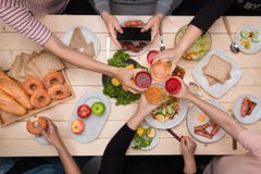 Enjoying dinner with friends. Top view of group of people havin royalty free stock images Enjoying dinner with friends. Top view of group of people havin royalty free stock images