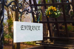 Entrance sign made of wood with white color hanging on a black steel beam royalty free stock photo Entrance sign made of wood with white color hanging on a black steel beam royalty free stock photo