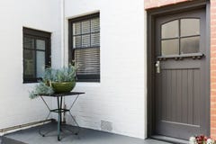 Entry porch and front door of an art deco style apartment Stock Image Entry porch and front door of an art deco style apartment Stock Image