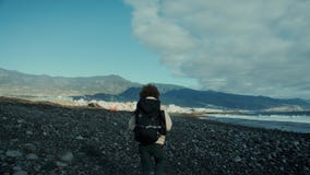 Young nomad traveller on epic mountain beach walk stock video Young nomad traveller on epic mountain beach walk stock video