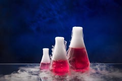 Erlenmeyer flask with red liquid on the table stock photography Erlenmeyer flask with red liquid on the table stock photography