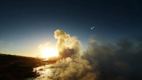 Eruption of geyser in Iceland. Winter cold colors, sun lighting through the steam stock video Eruption of geyser in Iceland. Winter cold colors, sun lighting through the steam stock video