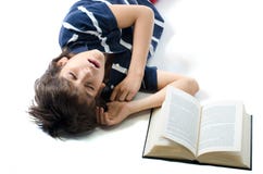 Estudiante joven que duerme con el libro abierto al lado de él imagen de archivo Estudiante joven que duerme con el libro abierto al lado de él imagen de archivo