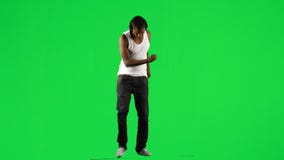 Ethnic boy with a headset on dancing music against green screen