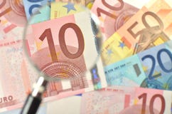 Euro Banknotes Under Magnifying Glass Royalty Free Stock Photos