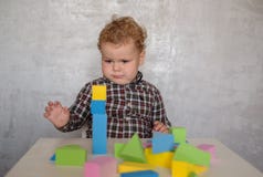 European boy builds a tower of colored blocks stock image European boy builds a tower of colored blocks stock image
