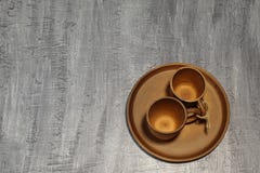 Valentine`s Day. Brown ceramic coffee cups tied with jute twine on ceramic platter. Dark concrete background. royalty free stock image Valentine`s Day. Brown ceramic coffee cups tied with jute twine on ceramic platter. Dark concrete background. royalty free stock image