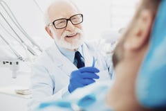 Gay male dentist displaying teeth cleaning stock images Gay male dentist displaying teeth cleaning stock images