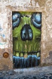Terrifying graffiti of the skull drawn on the blocked doorway in Stock Photo Terrifying graffiti of the skull drawn on the blocked doorway in Stock Photo