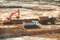 Excavator loading dumper truck stock photo Excavator loading dumper truck stock photo
