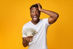 Excited Afro Guy Holding Money Shouting Touching Head, Yellow Background Stock Images Excited Afro Guy Holding Money Shouting Touching Head, Yellow Background Stock Images