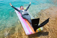 Excited businesswoman floating on lilo with laptop Royalty Free Stock Photo Excited businesswoman floating on lilo with laptop Royalty Free Stock Photo