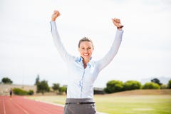 Excited businesswoman standing on the running track royalty free stock image Excited businesswoman standing on the running track royalty free stock image