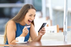 Excited on line buyer paying with credit card royalty free stock image Excited on line buyer paying with credit card royalty free stock image