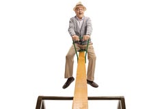Excited senior man on a seesaw royalty free stock image Excited senior man on a seesaw royalty free stock image