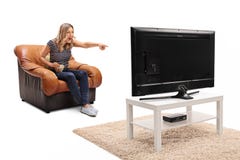 Excited woman seated watching something funny on TV royalty free stock images Excited woman seated watching something funny on TV royalty free stock images
