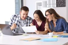 Excited workers reading a good results report royalty free stock images Excited workers reading a good results report royalty free stock images