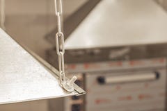 Exhaust umbrella in the kitchen of the restaurant on a blurred front and background with bokeh effect stock images Exhaust umbrella in the kitchen of the restaurant on a blurred front and background with bokeh effect stock images