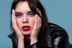 Exhausted young woman with red lips in black leather coat touching her head royalty free stock photos Exhausted young woman with red lips in black leather coat touching her head royalty free stock photos