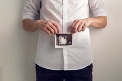 Expectant father holding hands ultrasound royalty free stock photo Expectant father holding hands ultrasound royalty free stock photo