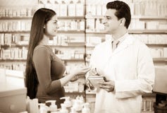 Experienced pharmacist counseling female customer royalty free stock photo Experienced pharmacist counseling female customer royalty free stock photo