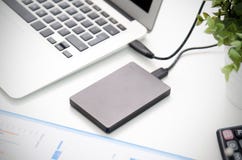 External backup disk hard drive connected to laptop Royalty Free Stock Images External backup disk hard drive connected to laptop Royalty Free Stock Images
