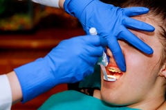 Extreme close up of hands working on dental braces with hatchet and mouth mirror, female mouth showing dental braces. Royalty Free Stock Images Extreme close up of hands working on dental braces with hatchet and mouth mirror, female mouth showing dental braces. Royalty Free Stock Images