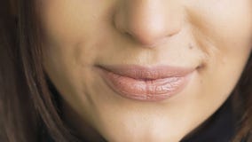 Extreme close up of woman licking and bitting lips. Slowly stock footage Extreme close up of woman licking and bitting lips. Slowly stock footage