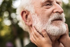 Face of aged man with hands of his grandchild stock photography Face of aged man with hands of his grandchild stock photography