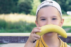 Face of a beautiful young caucasian boy with banana mustache on nature background. Royalty Free Stock Photo Face of a beautiful young caucasian boy with banana mustache on nature background. Royalty Free Stock Photo