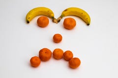 Face from fruits on white background. face made with fresh fruits. banana, mandarin tangerine royalty free stock photo Face from fruits on white background. face made with fresh fruits. banana, mandarin tangerine royalty free stock photo